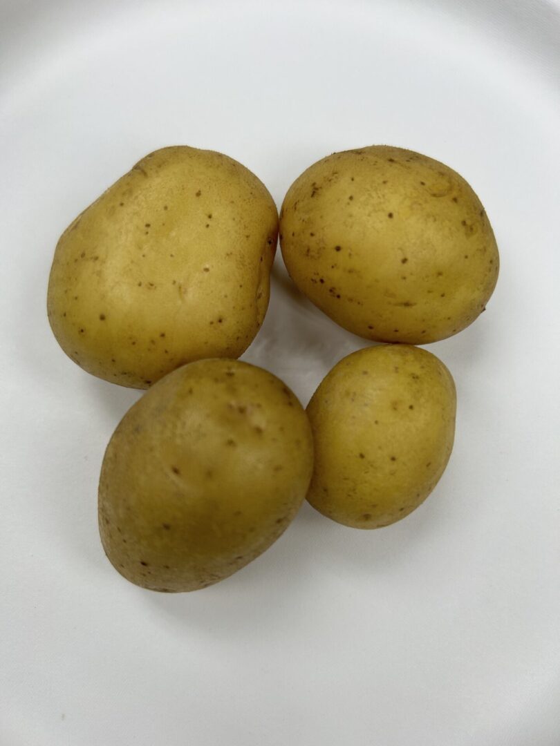 A top view of some potatoes kept on a white surface.