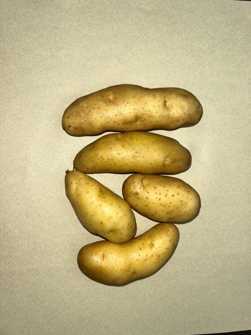A top view of some potatoes kept on a white surface